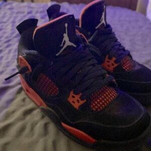 Jordan 4s Mid Red Thunders.